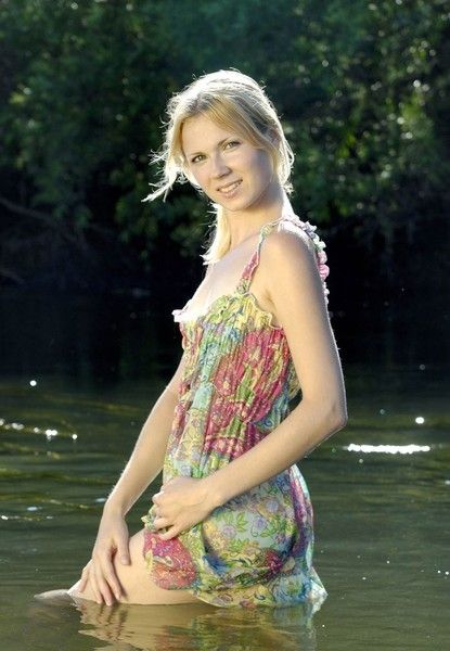 young blonde girl in a small river