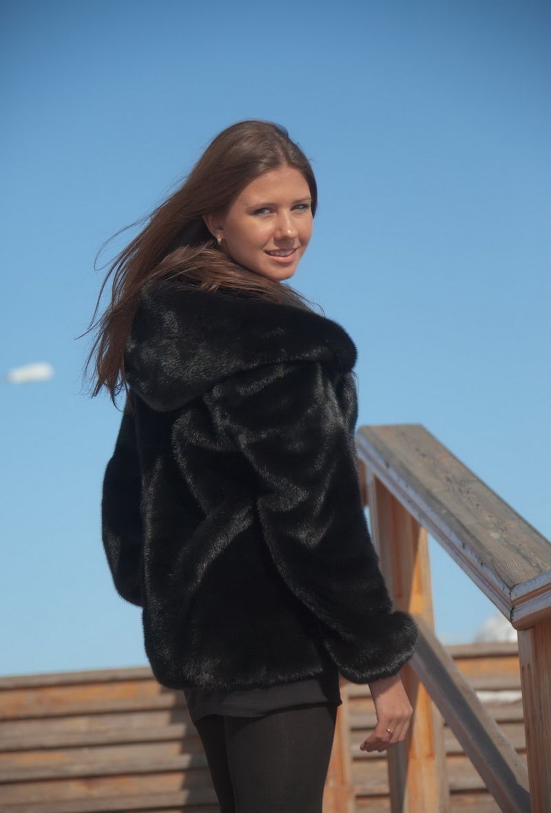 young brunette girl outside in the black coat