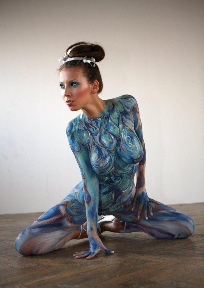 young brunette girl with body painting shows off on the floor