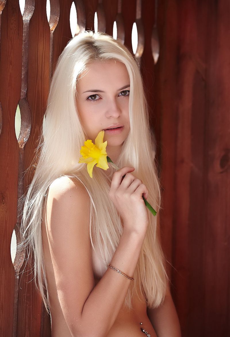 cute young swedish blonde girl strips a yellow sleeveless shirt, panties and short jeans at the house entrance