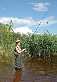 Babes: young brunette fish girl fishing in the swampland