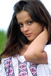 Babes: cute young brunette girl reveals on the field of wild flowers