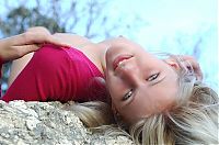 Nake.Me search results: cute young blonde girl posing on rocks in a tight pink sweater