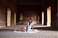 Babes: cute young red haired girl reveals her body on the floor of the large hall