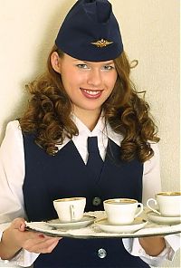 Babes: curly brunette girl strips from the stewardess uniform
