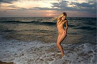 Babes: young blonde girl in the sea at sunset