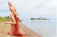 Babes: blonde girl with textile fabric at the lake with fortress