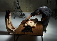 Babes: two asian japanese girls practicing a nyotaimori and serving sushi on a naked woman's body