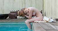 Babes: reddish blonde girl shows off at the swimming pool with towels