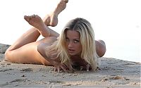 Babes: young blonde girl shows off on the sandy beach at the sea