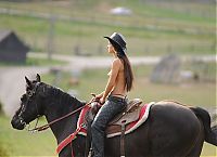 Babes: brunette girl shows off her cowboy skills with a horse and colt revolver